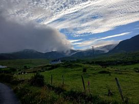 A view of mountains and clouds with a road at Sliabh League Mountain Lodge in TEILEANN near Kilcar, County Donegal