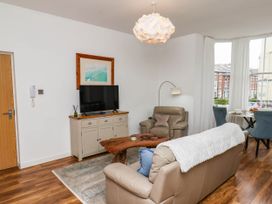 A living room with a sofa and television at Flat 1 in Whitby