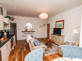A living room with a sofa and television at Flat 1 in Whitby