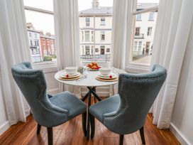 A dining room with a table set for breakfast at Flat 1 in Whitby