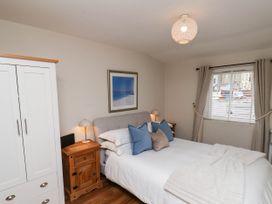 A bedroom with a bed and wardrobe at Flat 1 in Whitby