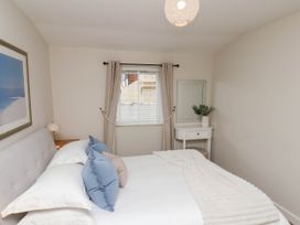 A bedroom with a bed and a side table at Flat 1 in Whitby