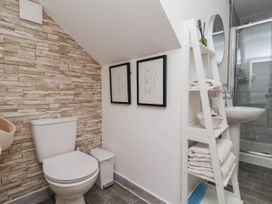 A bathroom with a toilet, sink, and shower at Flat 1 in Whitby