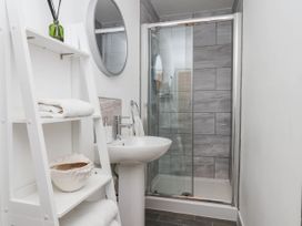A bathroom with a shower and sink at Flat 1 in Whitby