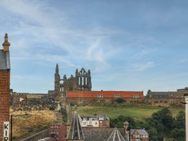 A view of ruins and buildings against a blue sky at Flat 1 in Whitby