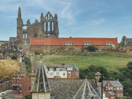 An outdoor view of ruins and houses at Flat 1 in Whitby