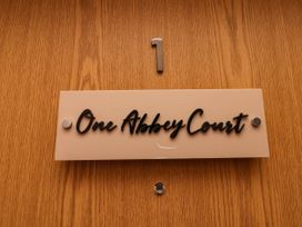 A nameplate on a door reading One Abbey Court with number 1 at Flat 1 in Whitby