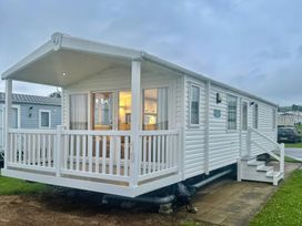 A mobile home with a deck and steps at 101 Bay View in Ayr