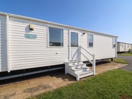 A caravan with steps and a door at The Lighthouse in Ayr