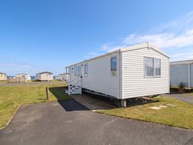A mobile home with steps and pavement at 101 Bay View in Ayr