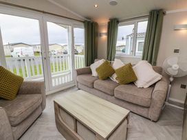 A living room with sofas and a coffee table at 101 Bay View Ayr