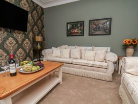 A living room with a sofa and coffee table at Lansdowne Grange in Bridlington