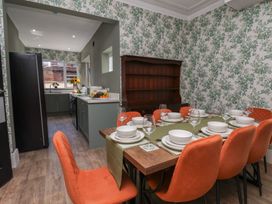 A dining room with a table set for dinner at Lansdowne Grange in Bridlington