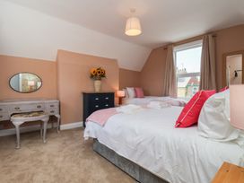 A bedroom with two beds and a dressing table at Lansdowne Grange in Bridlington