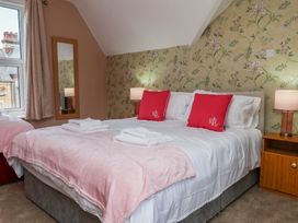 A bedroom with two beds and lamps at Lansdowne Grange in Bridlington
