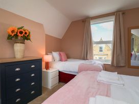 A bedroom with two beds and a dresser at Lansdowne Grange in Bridlington