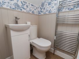 A bathroom with a sink, toilet, and towel radiator at Lansdowne Grange in Bridlington