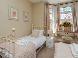 A bedroom with two beds and a dresser at Lansdowne Grange in Bridlington