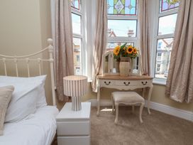 A bedroom with a bed and vanity table at Lansdowne Grange in Bridlington