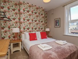 A bedroom with a bed and side table at Lansdowne Grange in Bridlington