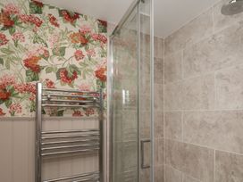 A bathroom featuring a shower and towel rail at Lansdowne Grange in Bridlington