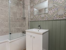 A bathroom with a bathtub and sink at Lansdowne Grange in Bridlington