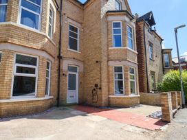 An exterior view of a house with windows and a pathway at Lansdowne Grange in Bridlington