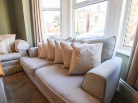 A living room with a sofa and cushions at Lansdowne Grange in Bridlington