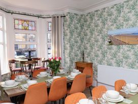 A dining room with a table set for dinner at Lansdowne Grange in Bridlington