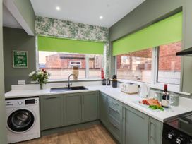 A kitchen with a sink and appliances at Lansdowne Grange in Bridlington