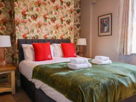 A bedroom with a bed and pillows at Lansdowne Grange in Bridlington