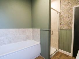A bathroom with a bathtub and shower at Lansdowne Grange in Bridlington