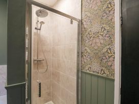 A shower with a glass door in a bathroom at Lansdowne Grange in Bridlington