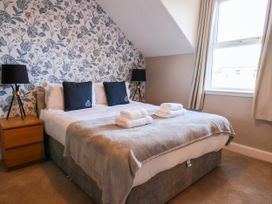 A bedroom with a bed and bedside tables at Lansdowne Grange in Bridlington