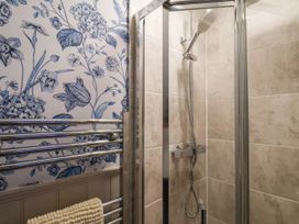 A bathroom with a shower and towel rail at Lansdowne Grange in Bridlington