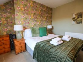 A bedroom with a bed and two bedside lamps at Lansdowne Grange in Bridlington
