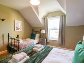 A bedroom with two beds and a window at Lansdowne Grange in Bridlington