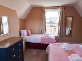 A bedroom with two beds and a dresser at Lansdowne Grange in Bridlington