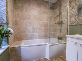 A bathroom featuring a bathtub and shower at Lansdowne Grange in Bridlington