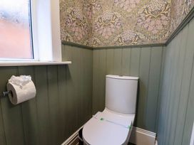 A bathroom with a toilet and window at Lansdowne Grange in Bridlington