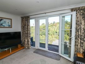 A living room with a television and sliding doors at 2 Inglewood Apartments, Dartmouth