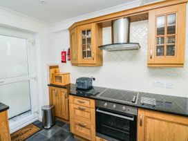 A kitchen with cabinets and appliances at 2 Inglewood Apartments Dartmouth