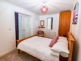 A bedroom with a bed and a mirror at 2 Inglewood Apartments in Dartmouth