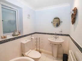 A bathroom containing a toilet, sink, and towel rail at 2 Inglewood Apartments in Dartmouth