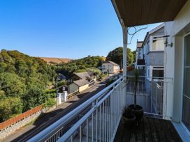 A balcony with a view of houses and trees at 2 Inglewood Apartments in Dartmouth