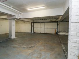 A garage with concrete floor and garage door at 2 Inglewood Apartments in Dartmouth