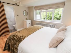A bedroom with a bed and window at Hedley Dene Cottage in Longhorsley