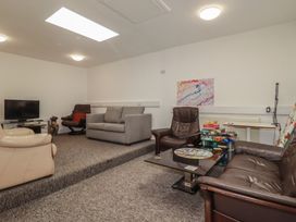 A living room with sofas and a television at Newseal House 