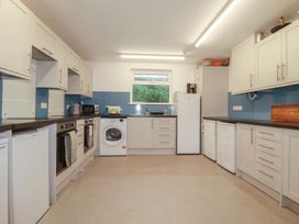 A kitchen with cabinets and appliances at Newseal House