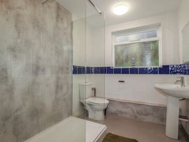 A bathroom with a shower, toilet, and sink at Newseal House 